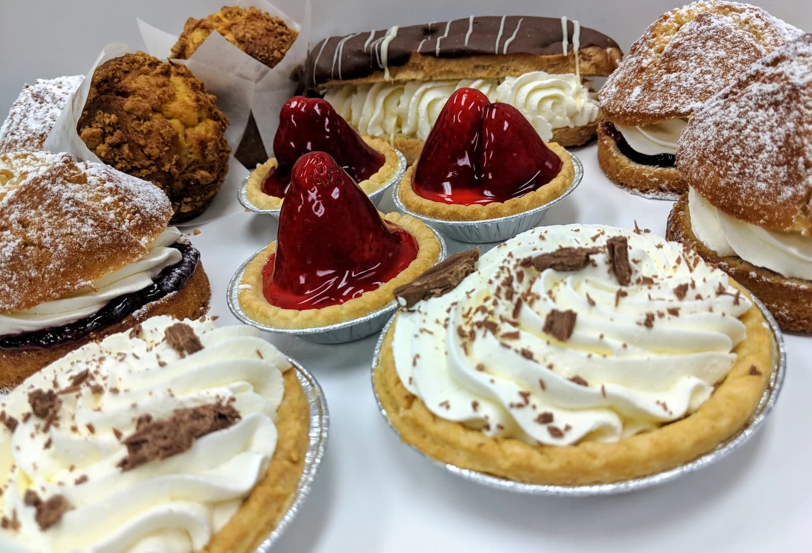Cream cakes, strawberry tarts, muffins and a chocolate eclair from British Pride Bakery.