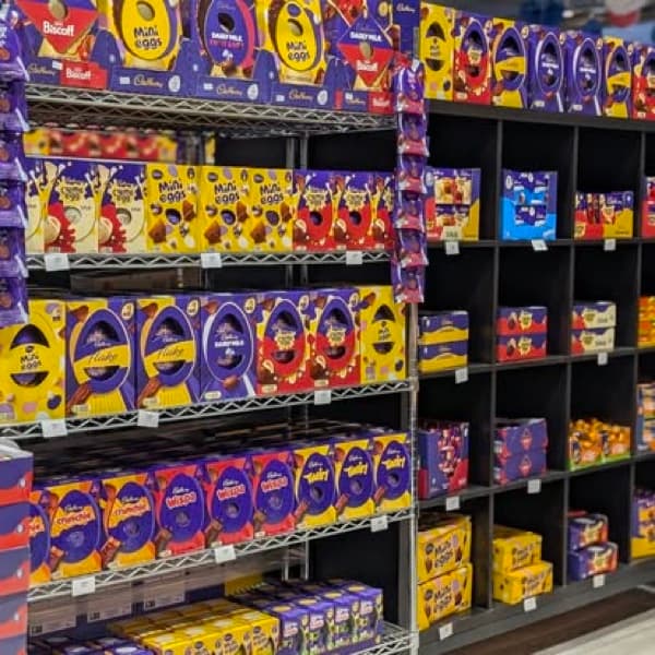 Shop shelves filled with boxed British Easter eggs and seasonal chocolate.